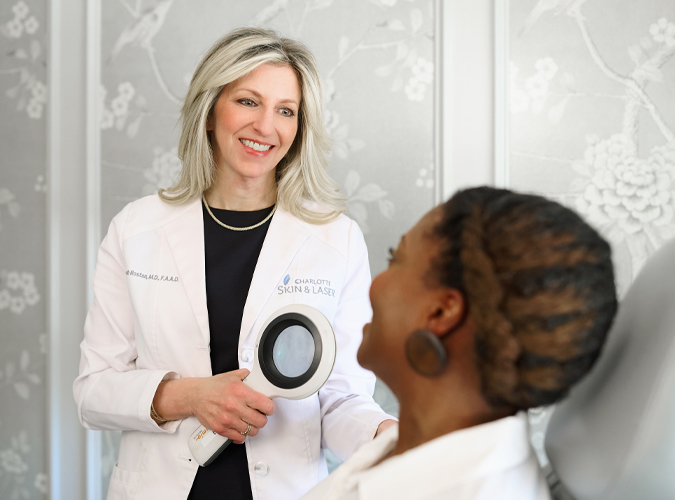 Dr. Rostan speaking with a patient