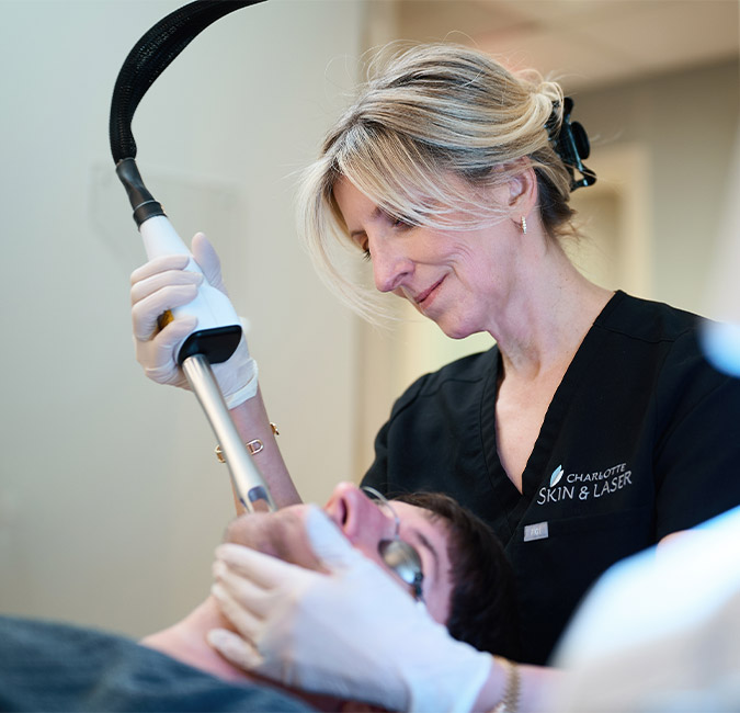 Dr. rostan performing procedure on client